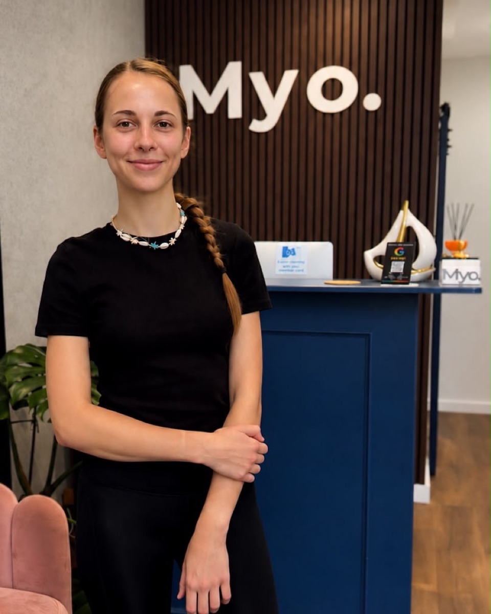 Eliška Majerechová standing at the Myo Wellness reception desk