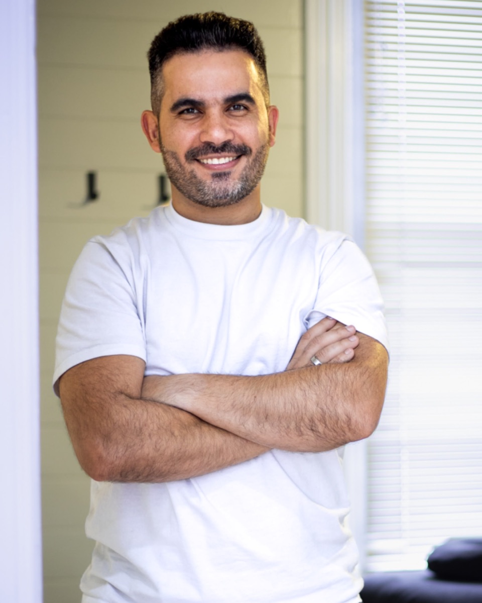 Felipe Costa standing with his arms crossed in a treatment room at the Westgate clinic