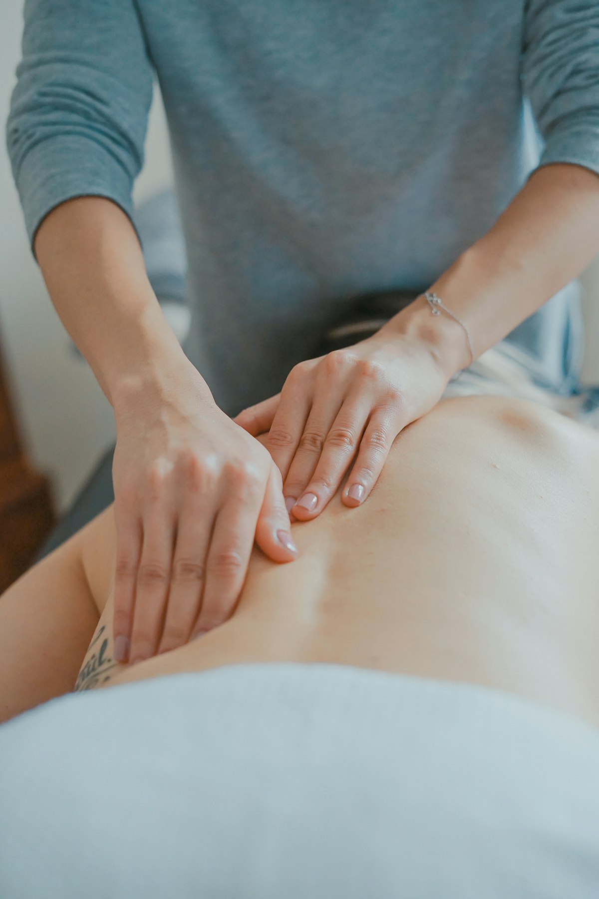 A physiotherapist assessing shoulder movement